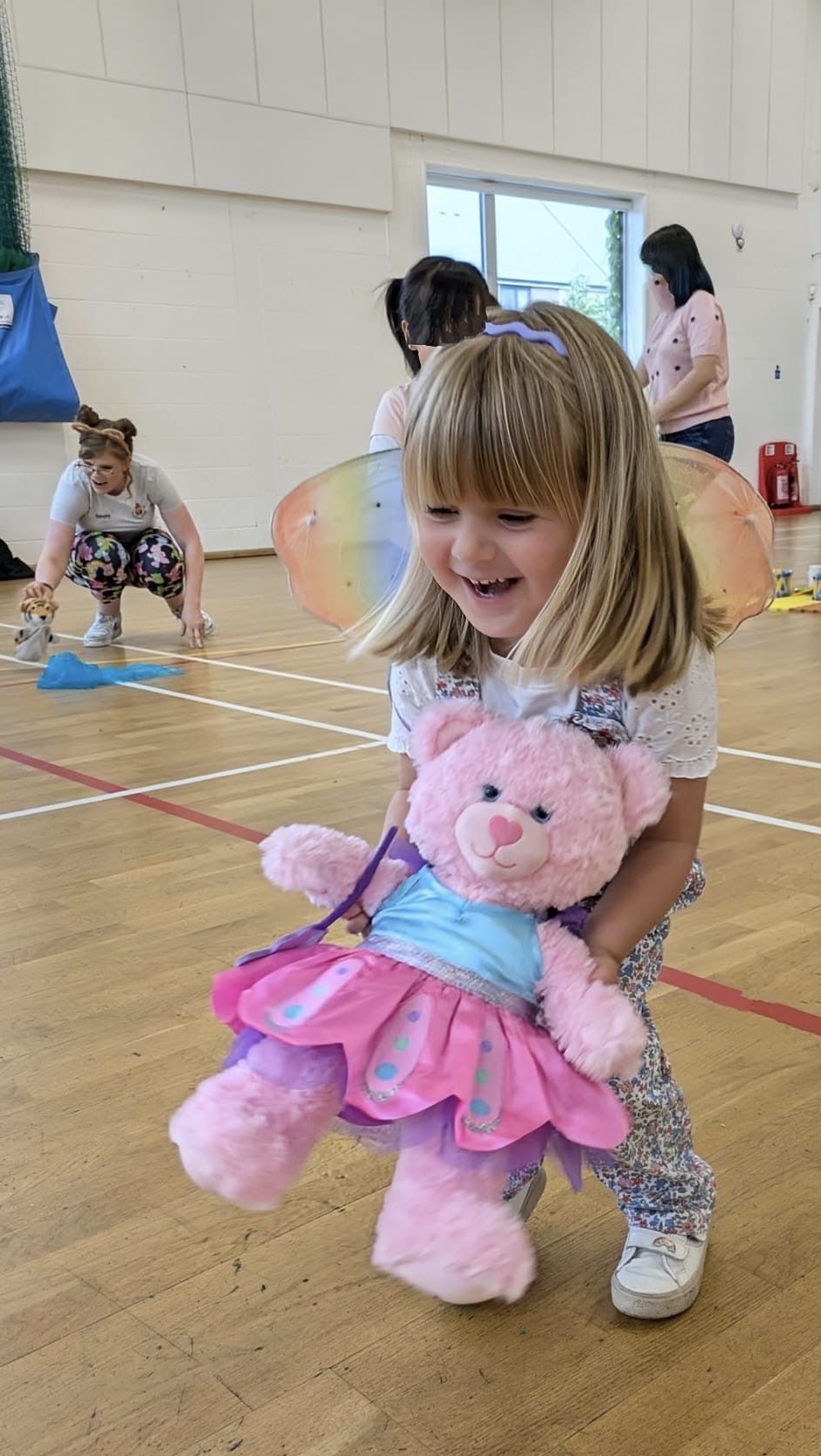 Young child playing with toys during group music class